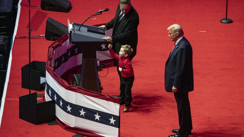 Trump, Musk, and Musk's son at a Trump victory rally.