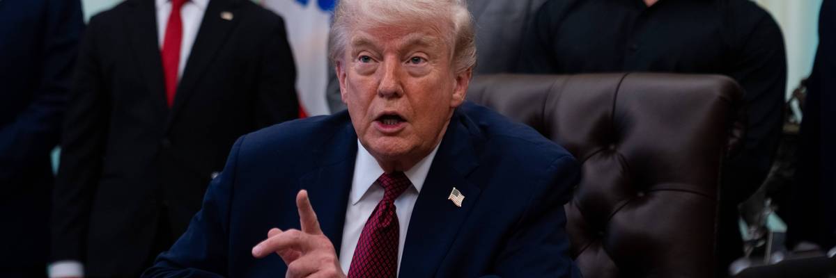 Trump points his finger while speaking sitting in the Oval Office