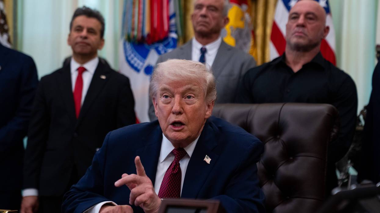 Trump points his finger while speaking sitting in the Oval Office