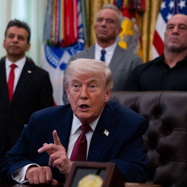 Trump points his finger while speaking sitting in the Oval Office