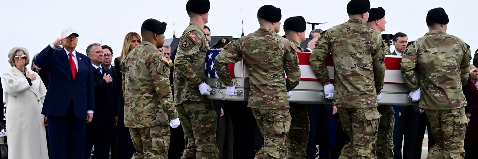 trump-salutes-as-soldiers-carry-a-flag-d