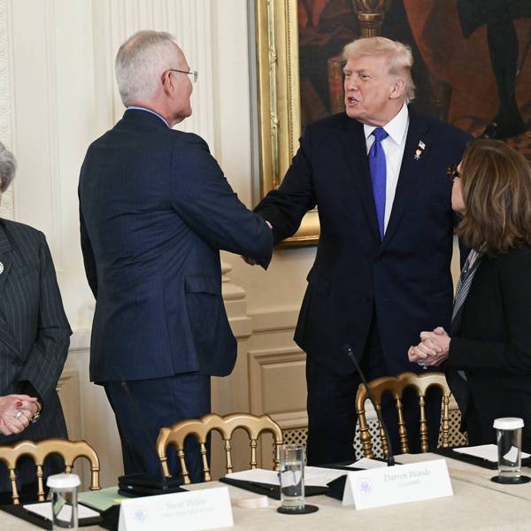 Trump shakes hands with Woods following Venezuelan invasion.