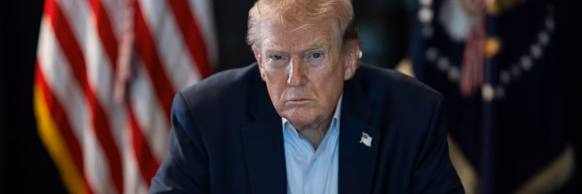 Trump sits with a stern look