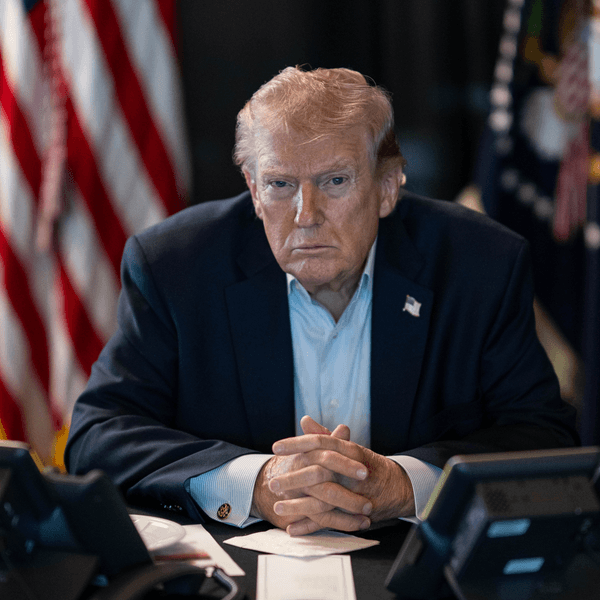 Trump sits with a stern look