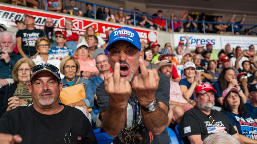 Trump supporter giving to middle fingers to the photographer