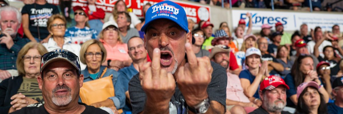 Trump supporter giving to middle fingers to the photographer