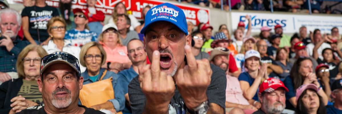 Trump supporter giving to middle fingers to the photographer