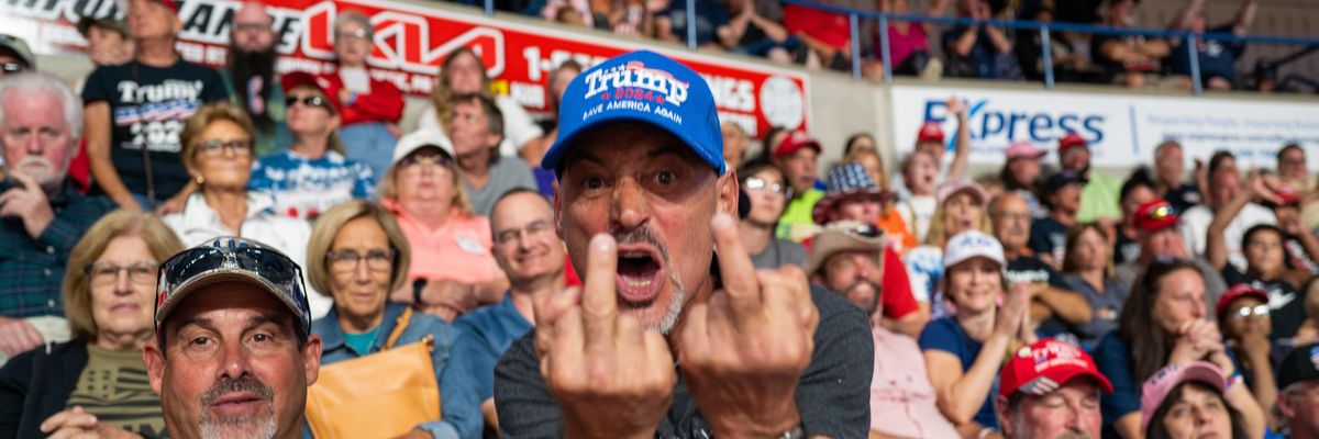 Trump supporter giving to middle fingers to the photographer