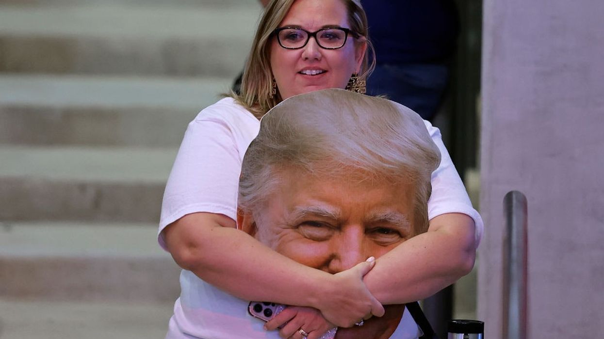 Trump supporter holds picture of his face