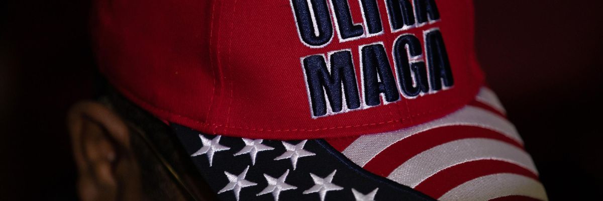 Trump supporter with a hat that reads "Ultra MAGA"