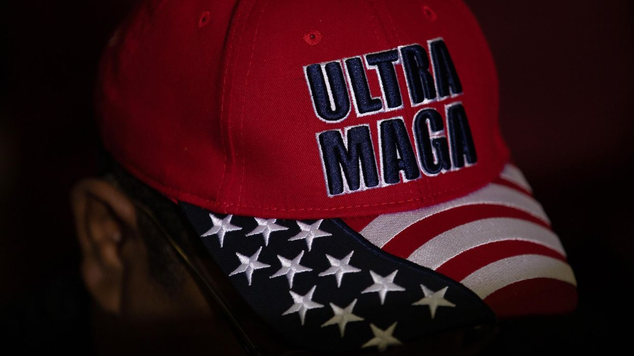 Trump supporter with a hat that reads "Ultra MAGA"