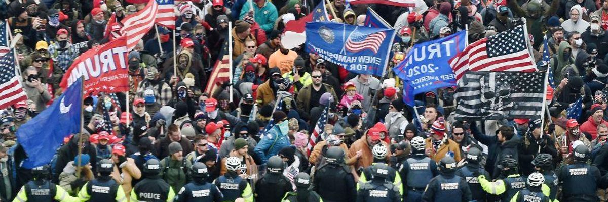 Trump supporters carrying flags clash with police at the US Capitol