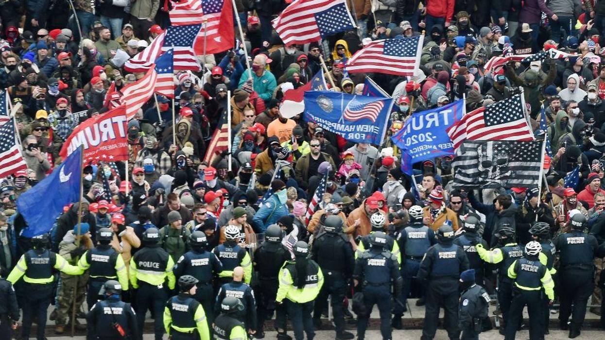Trump supporters carrying flags clash with police at the US Capitol