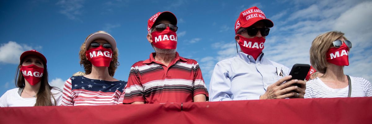 Trump supporters in MAGA masks at a 2020 North Carolina rally.