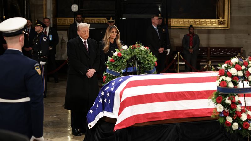 Trump views Carter's coffin.
