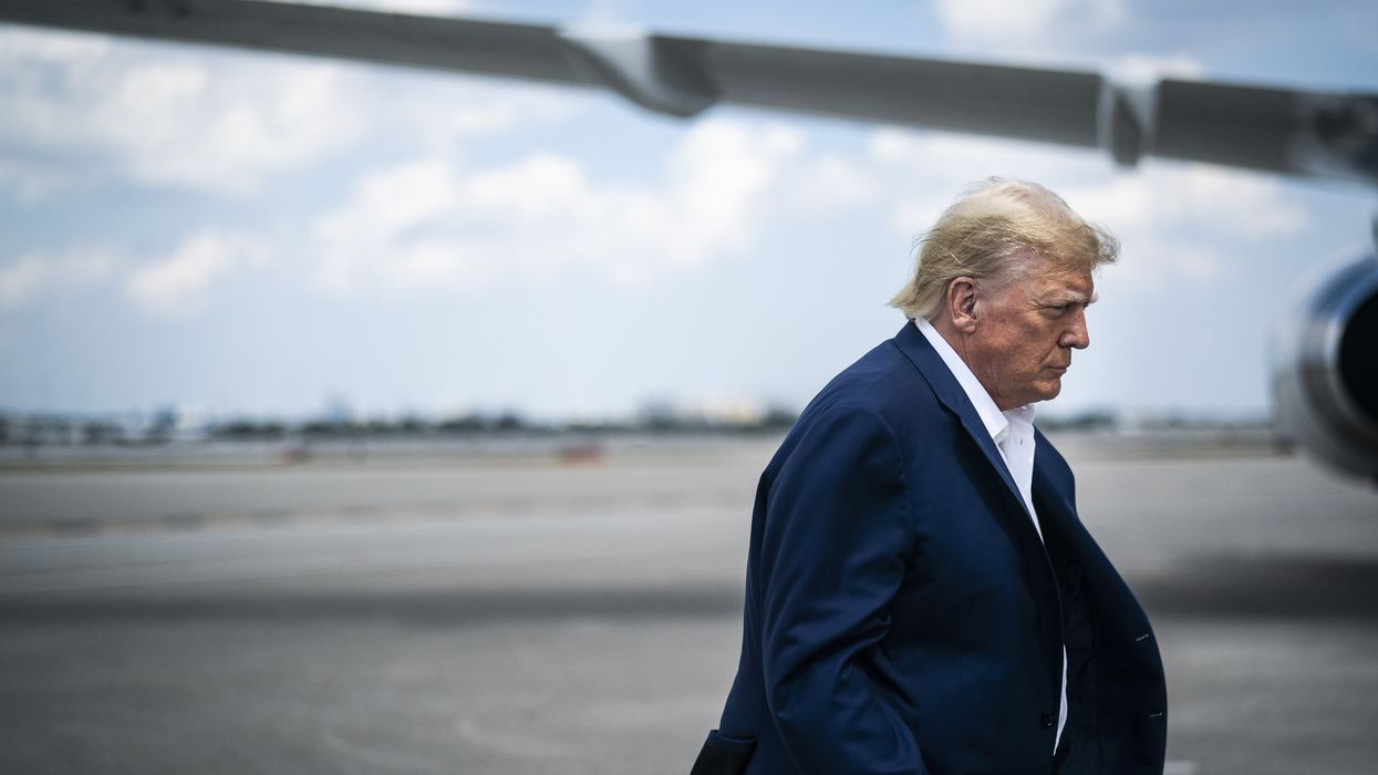 Trump with an airplane wing behind him.