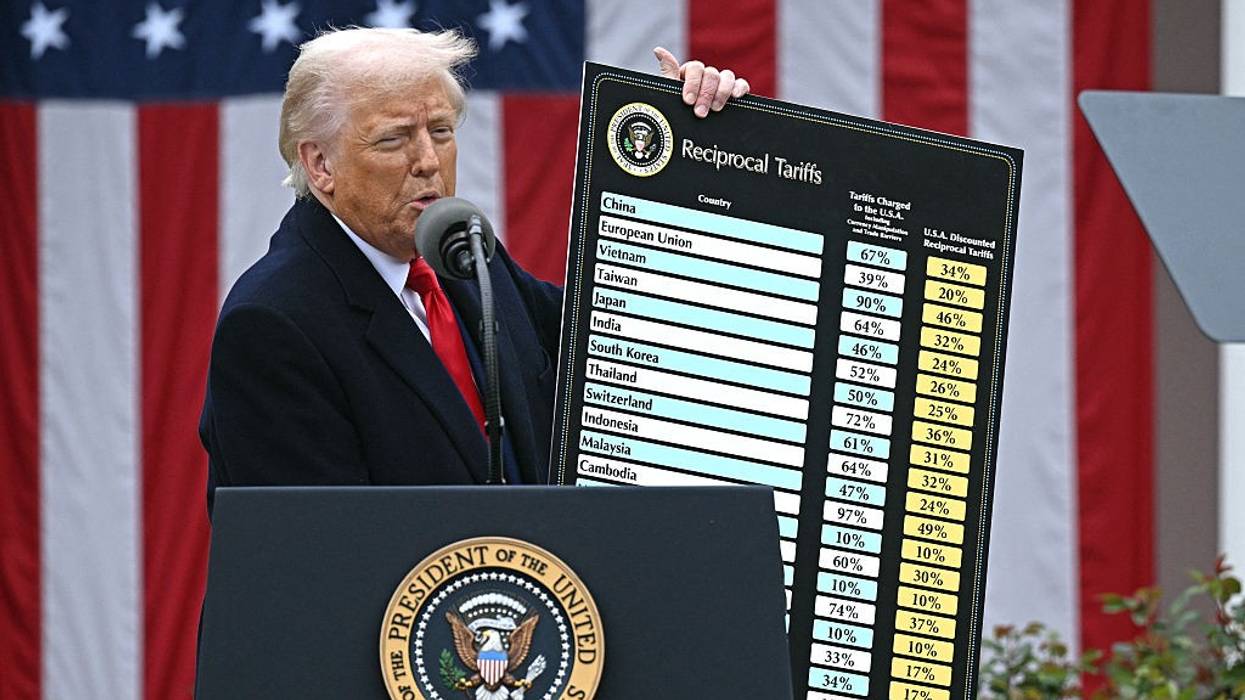 Trump with chart of reciprocal tariffs.