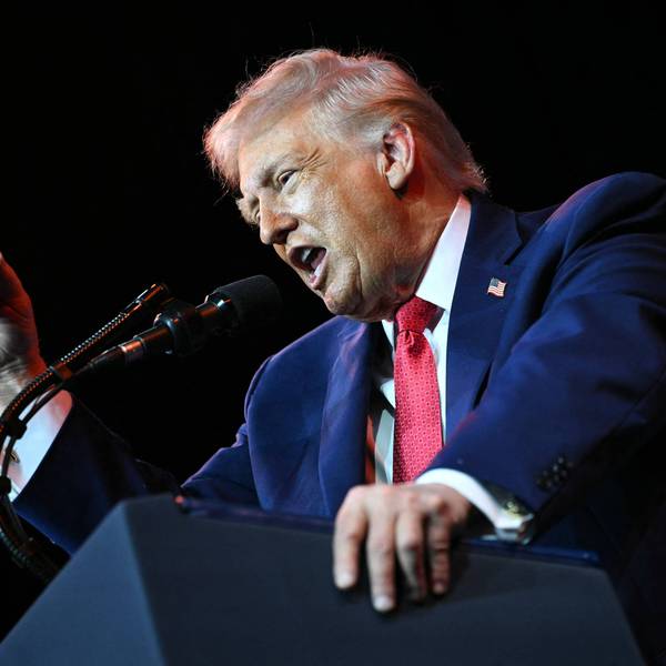 Trump yells into a microphone.