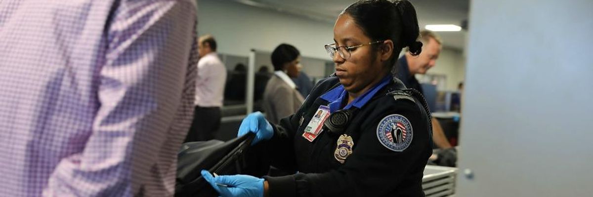 TSA worker screens luggage at LaGuardia Airport on September 26, 2017 in New York City.