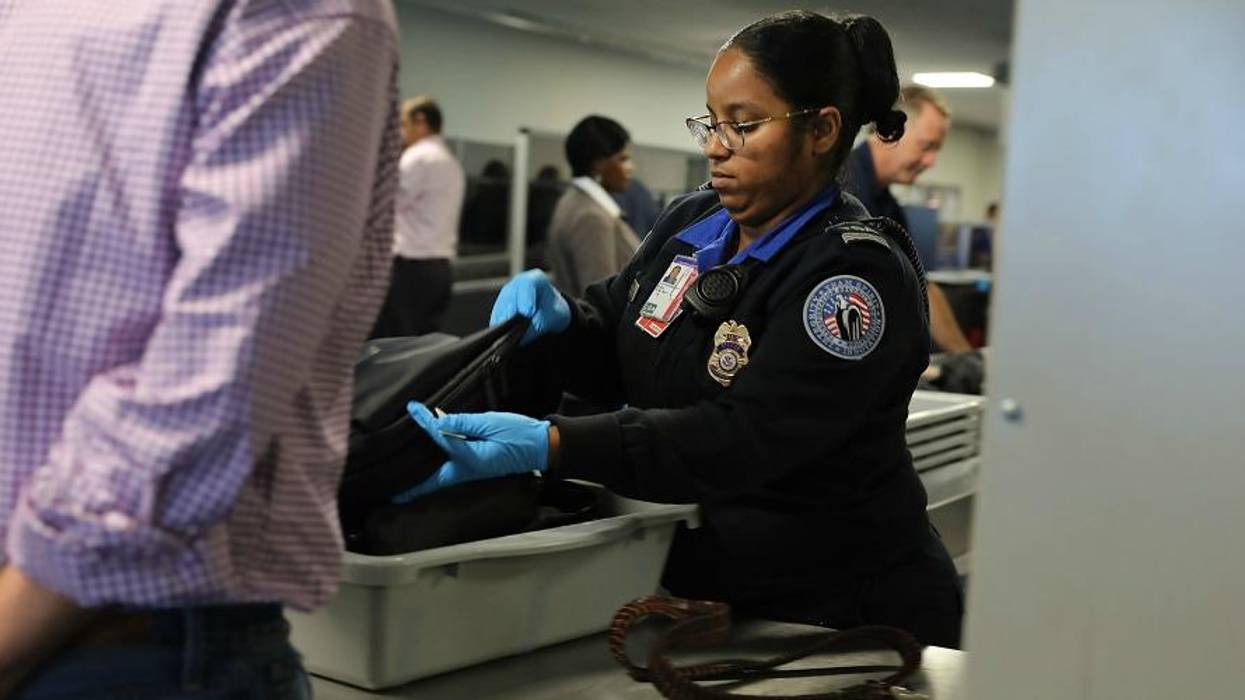 TSA worker screens luggage at LaGuardia Airport on September 26, 2017 in New York City.