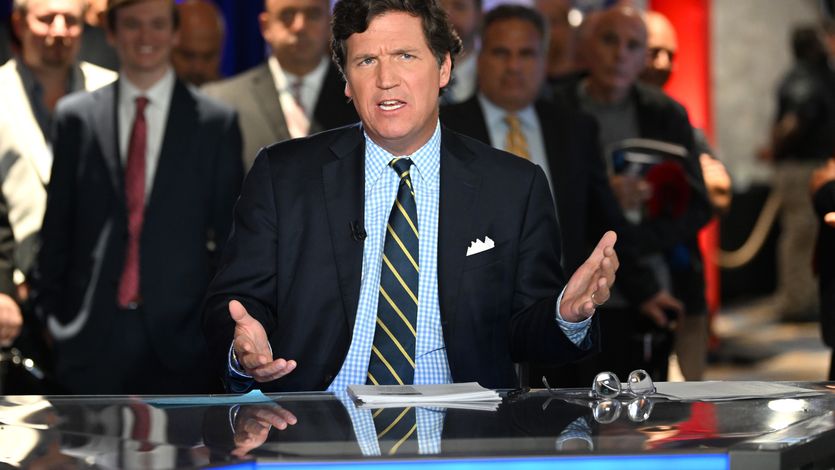 Tucker Carlson speaks during an event
