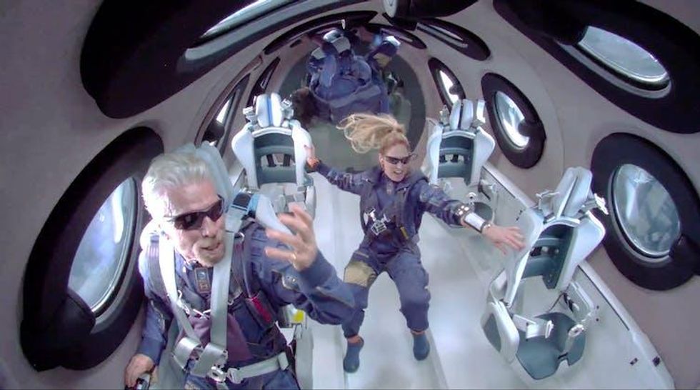 Two people in space suits attain zero gravity.