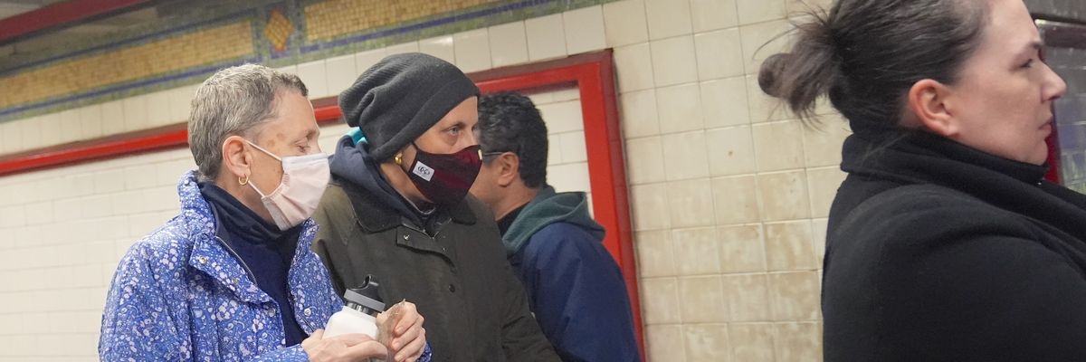Two people wear face masks in New York City