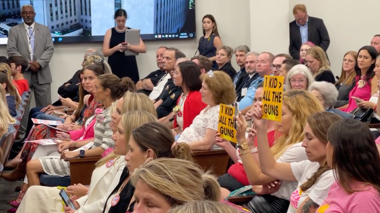 Two pro-gun control protesters hold up signs