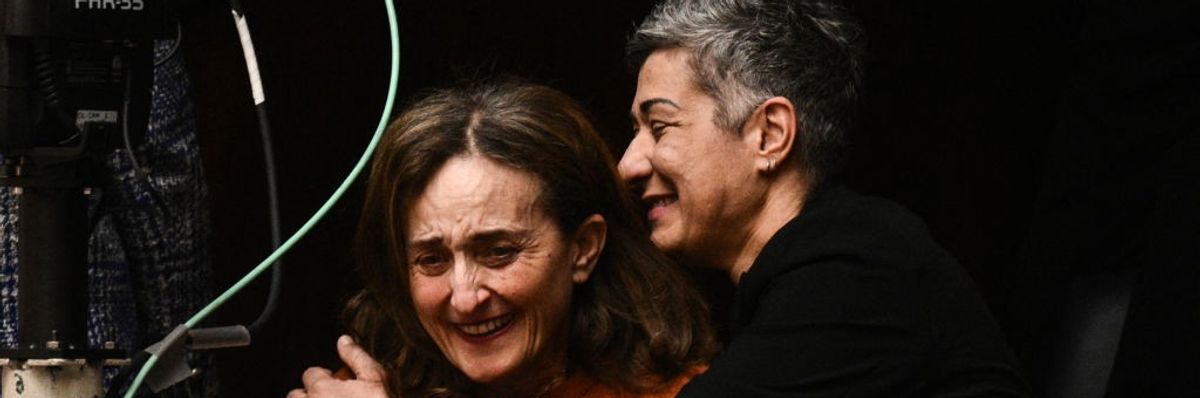 Two women embrace in Greece's Parliament after it voted to legalize same-sex marriage