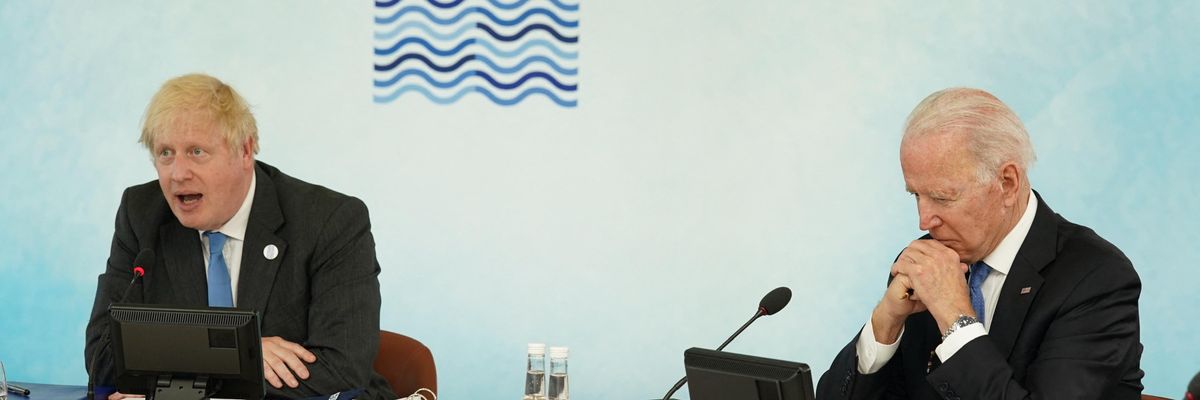 U.K. Prime Minister Boris Johnson sits alongside U.S. President Joe Biden