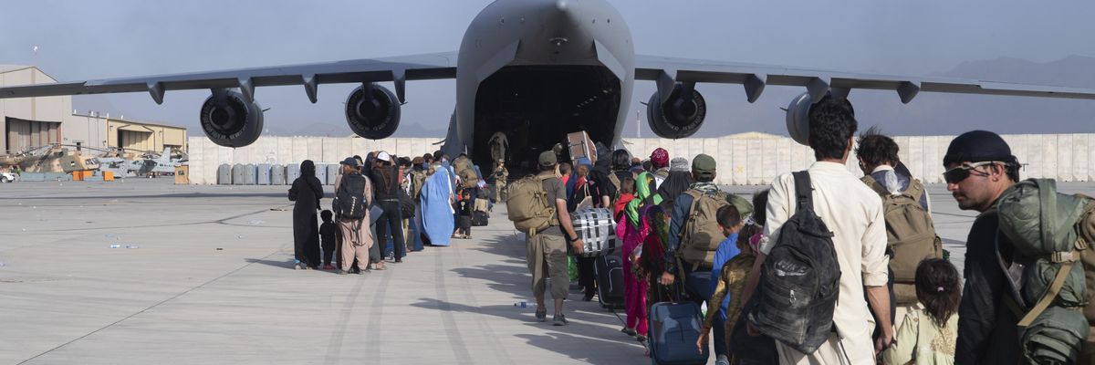 U.S. Air Force l load passengers aboard a U.S. Air Force C-17 Globemaster III in support of the Afghanistan evacuation at Hamid Karzai International Airport