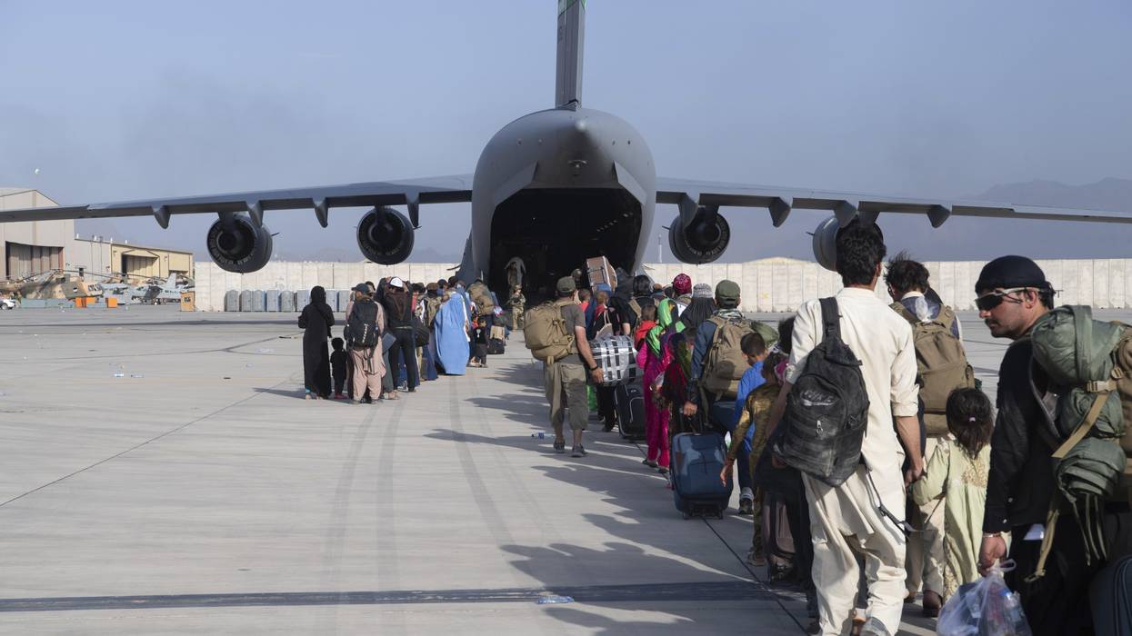 U.S. Air Force l load passengers aboard a U.S. Air Force C-17 Globemaster III in support of the Afghanistan evacuation at Hamid Karzai International Airport