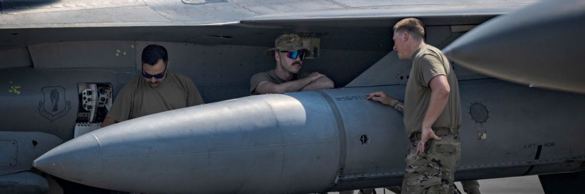 U.S. Air Force soldiers stand around an F16.