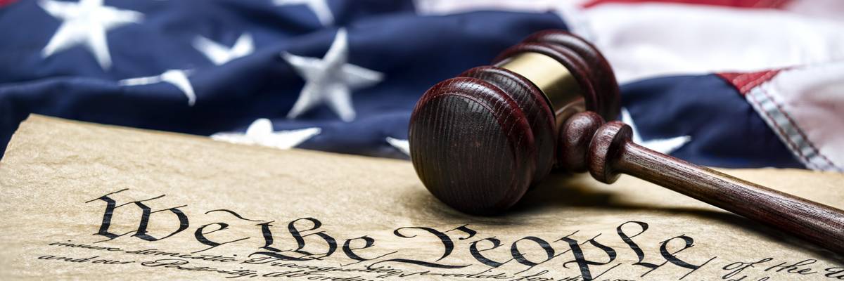 U.S. flag, gavel, and Constitution.