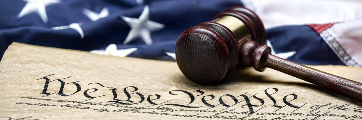 U.S. flag, gavel, and Constitution.