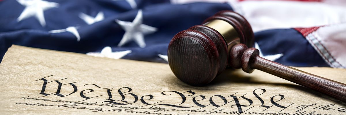 U.S. flag, gavel, and Constitution.