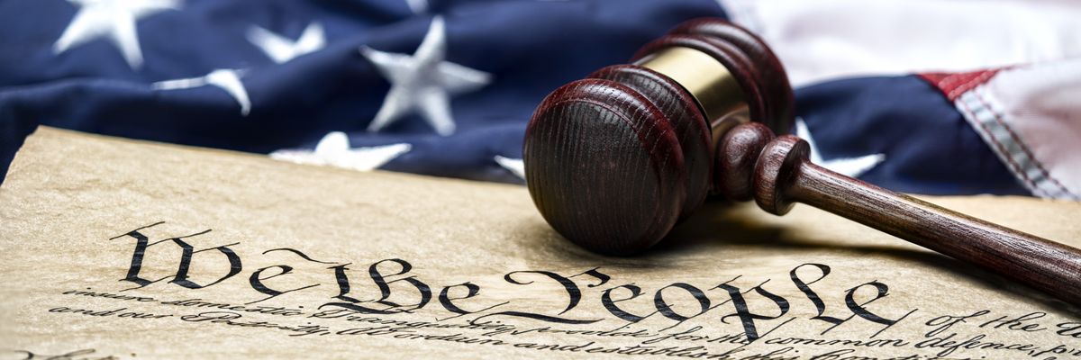 U.S. flag, gavel, and Constitution.