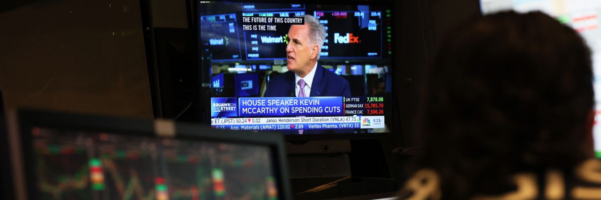 U.S. House Speaker Kevin McCarthy is seen on a television screen giving an interview