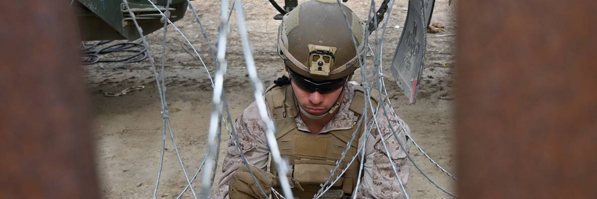 U.S. Marine installing concertina wire at border wall.