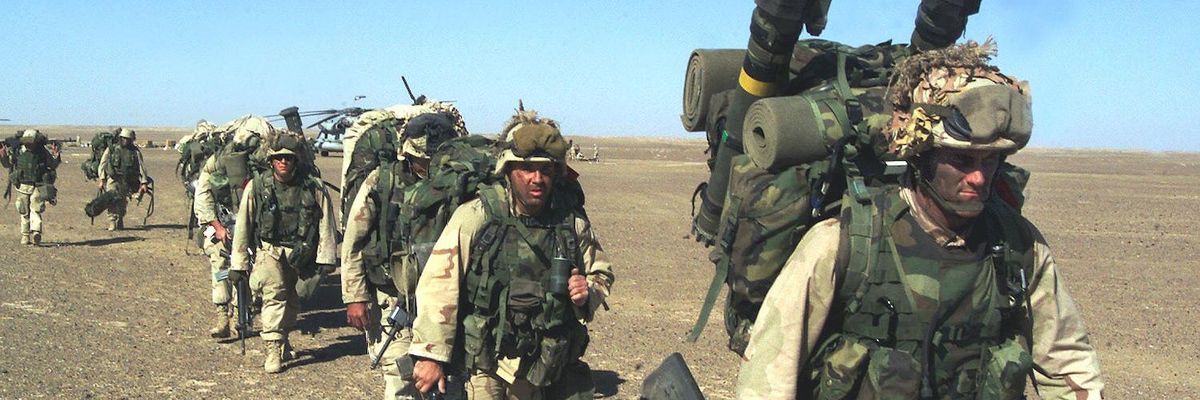 U.S. Marines march in single file in the desert in Afghanistan.