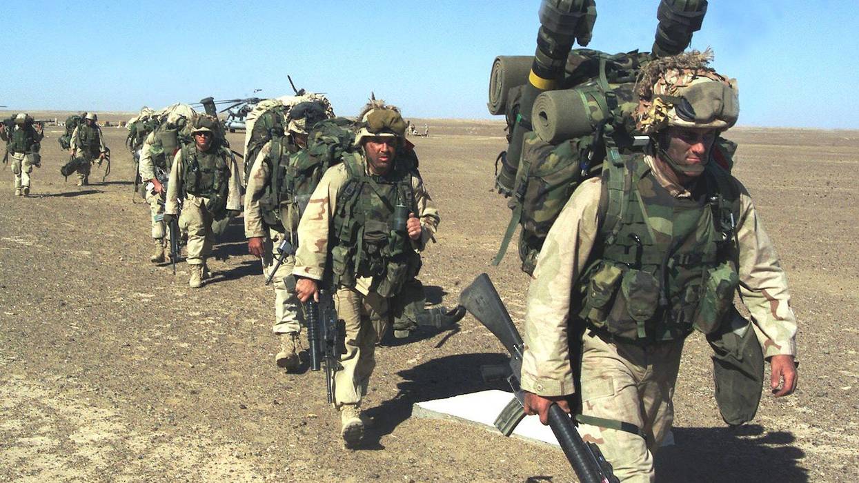 U.S. Marines march in single file in the desert in Afghanistan.