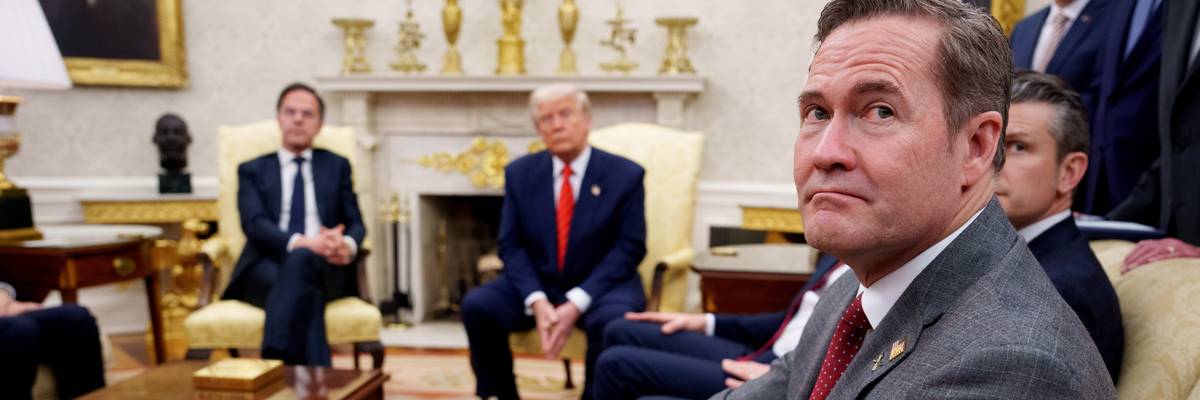 U.S. President Donald Trump, accompanied by U.S. National Security Adviser Michael Waltz (R), takes a question from a reporter