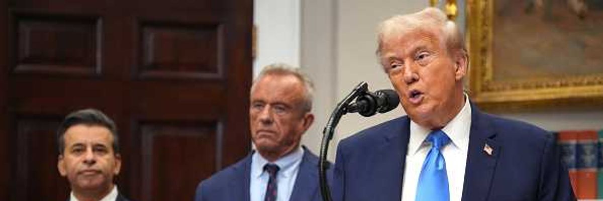 U.S. President Donald Trump (R), accompanied by Health and Human Services Secretary Robert F. Kennedy Jr. (C) and Food and Drug Administration Commissioner Dr. Marty Makary,