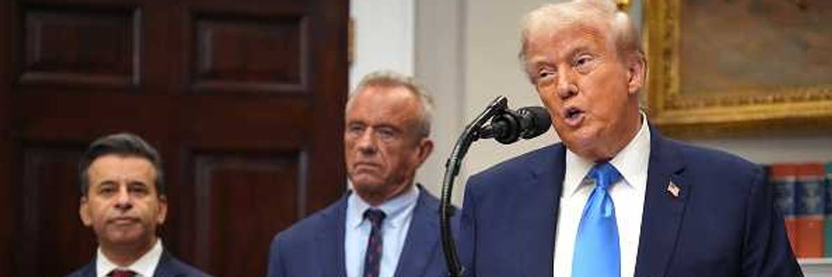 U.S. President Donald Trump (R), accompanied by Health and Human Services Secretary Robert F. Kennedy Jr. (C) and Food and Drug Administration Commissioner Dr. Marty Makary,