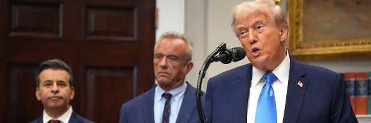 U.S. President Donald Trump (R), accompanied by Health and Human Services Secretary Robert F. Kennedy Jr. (C) and Food and Drug Administration Commissioner Dr. Marty Makary,