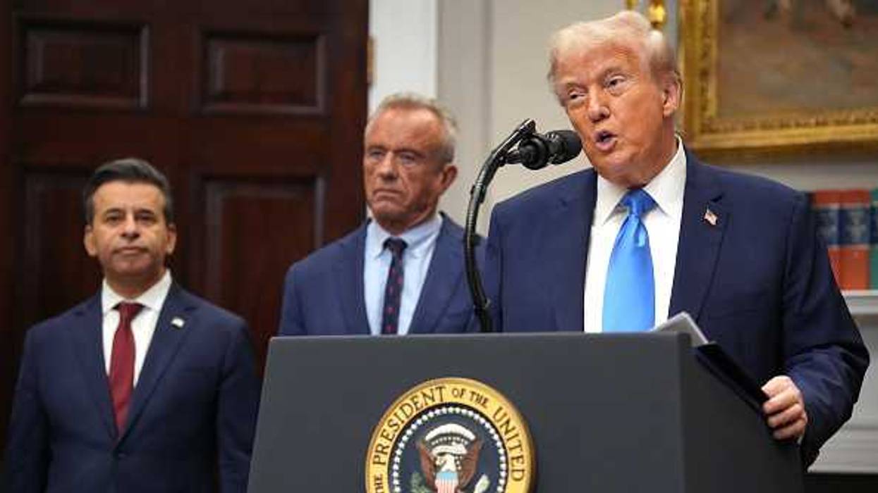 U.S. President Donald Trump (R), accompanied by Health and Human Services Secretary Robert F. Kennedy Jr. (C) and Food and Drug Administration Commissioner Dr. Marty Makary,