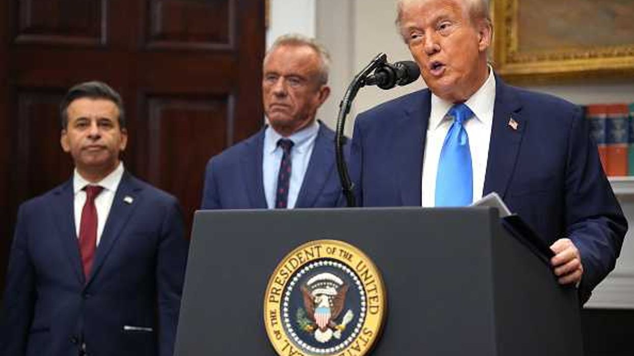 U.S. President Donald Trump (R), accompanied by Health and Human Services Secretary Robert F. Kennedy Jr. (C) and Food and Drug Administration Commissioner Dr. Marty Makary,