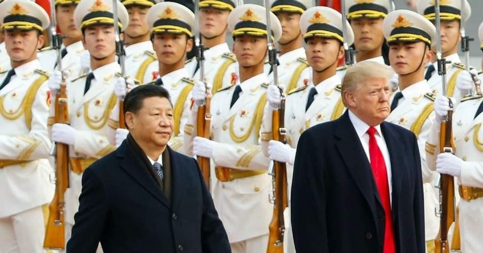 U.S. President Donald Trump takes part in a welcoming ceremony with China's President Xi Jinping on November 9, 2017 in Beijing, China. (Photo: Thomas Peter-Pool/Getty Images)