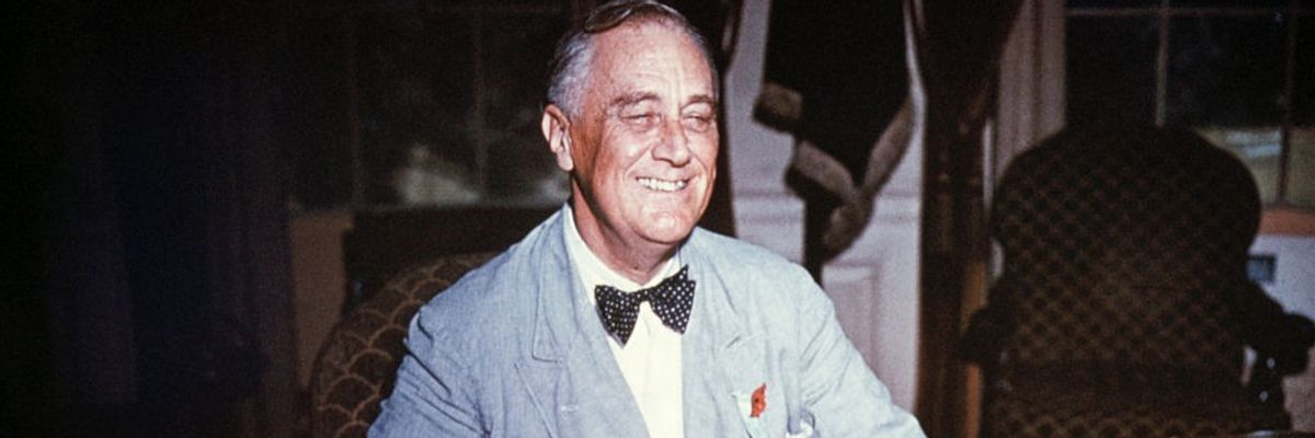 U.S. President Franklin Delano Roosevelt smiling at his desk