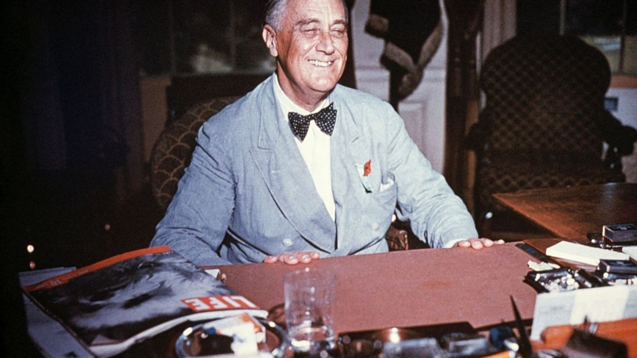 U.S. President Franklin Delano Roosevelt smiling at his desk